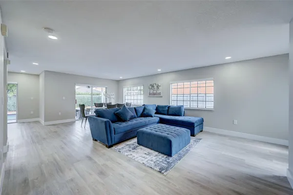 a living room with furniture window and wooden floor