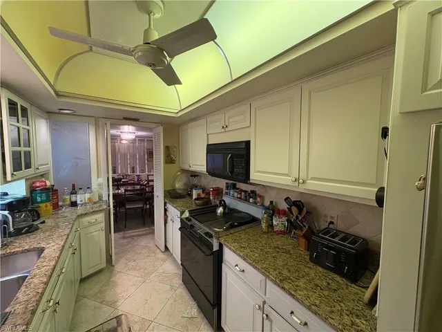 a kitchen with a stove a sink and a refrigerator
