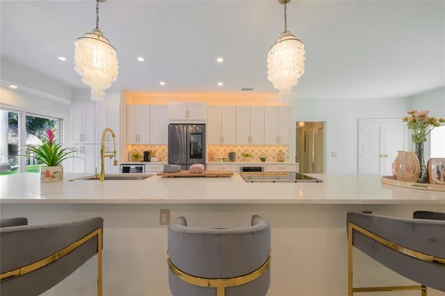 a kitchen with a table a sink and cabinets