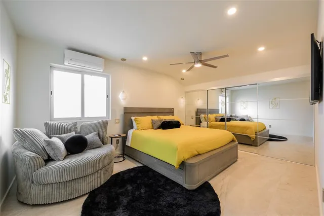 a spacious bedroom with a bed and window