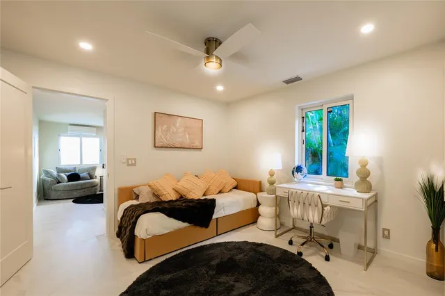 a bedroom with a bed gym equipment and a window