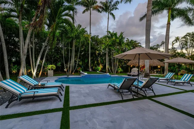 a view of a sitting area with chairs and wooden fence