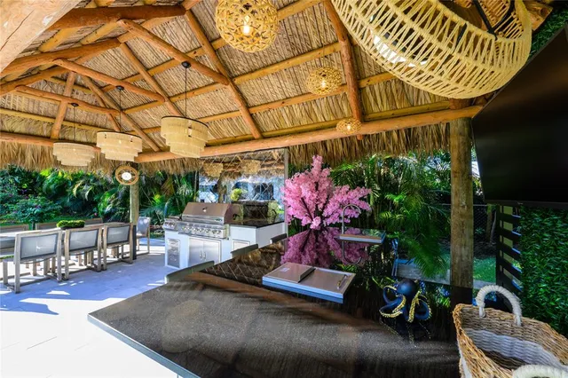 a view of a backyard with table and chairs under an umbrella