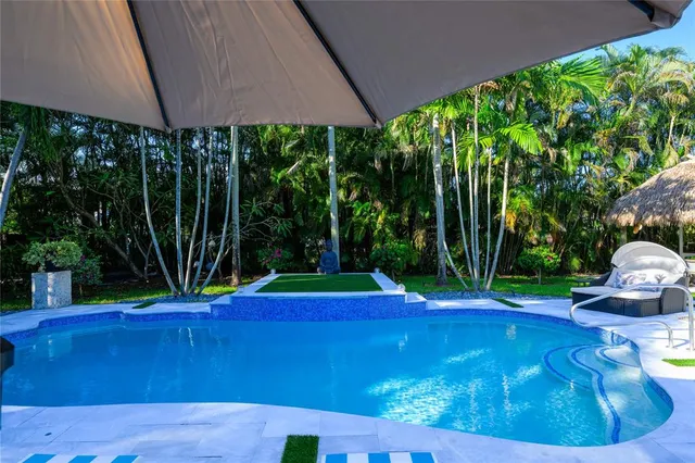 a view of a house with backyard and sitting area