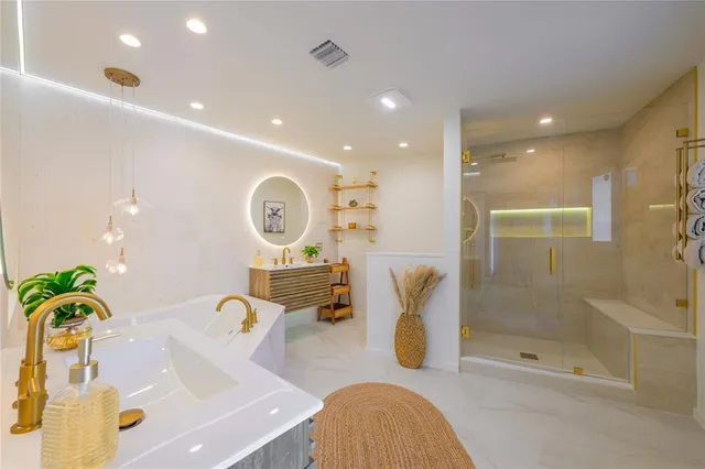 a bathroom with a tub sink and mirror