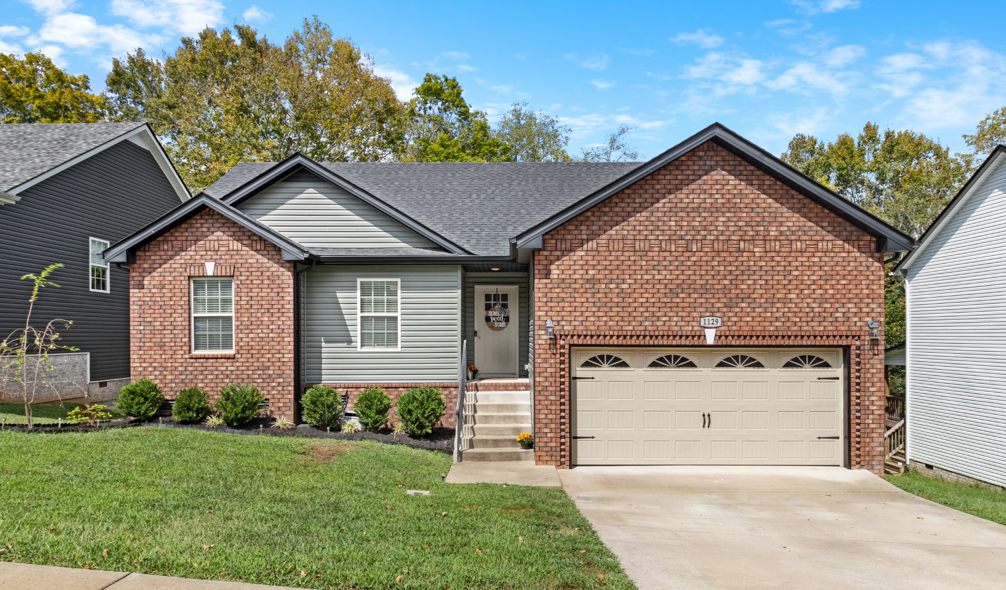 1129 Racker Drive Clarksville, TN 37043 - Photo 1 of 12 a view of a house with a yard plants and large tree