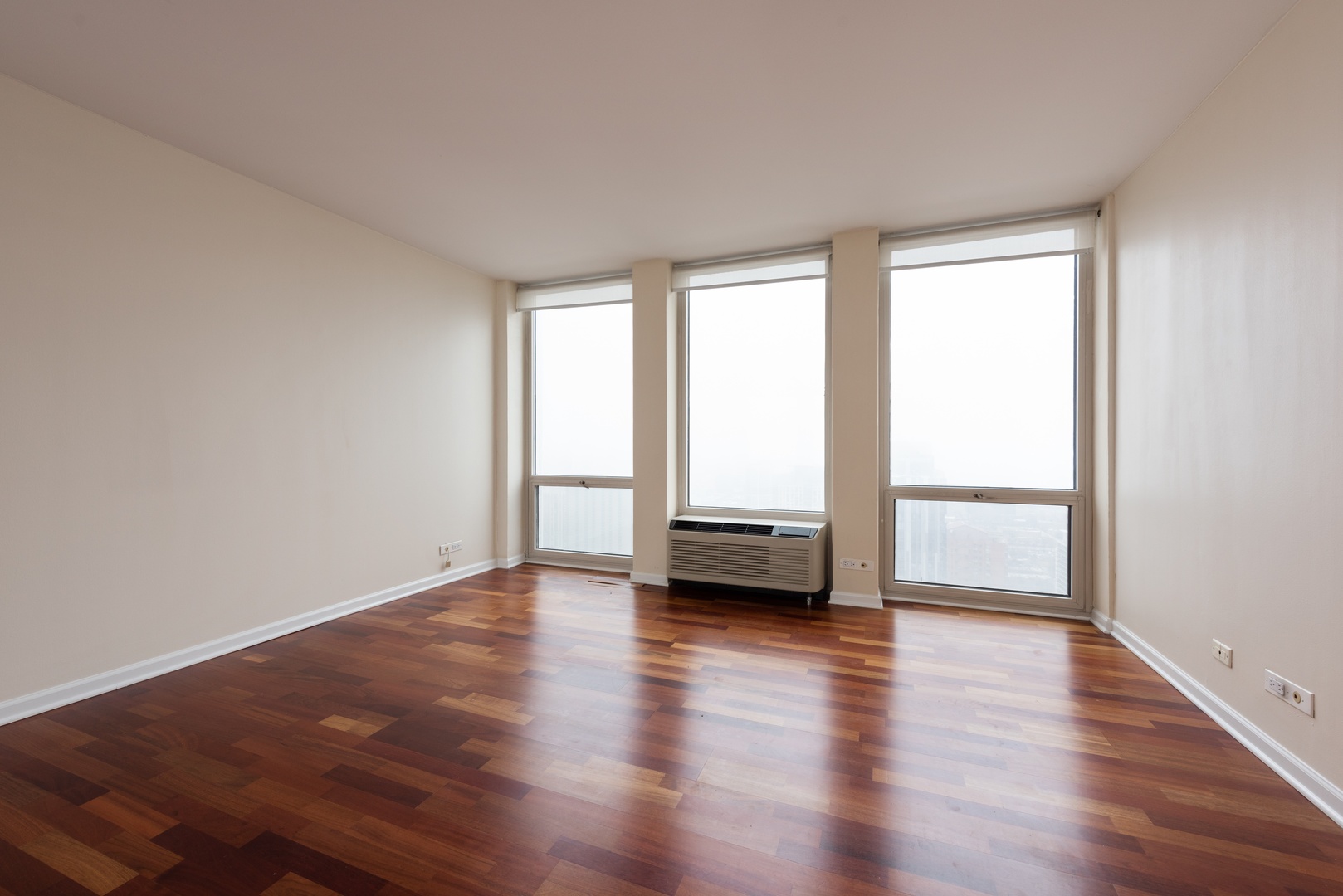 111 East Chestnut Street, Unit 45B Chicago, IL 60611 - Photo 13 of 27 a view of empty room with wooden floor and fan