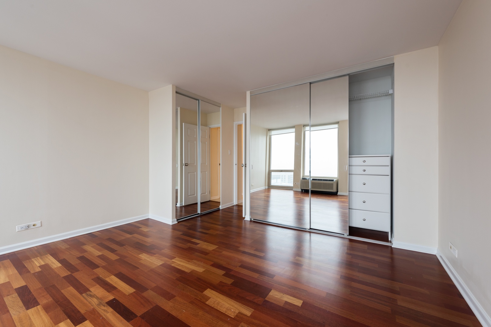 111 East Chestnut Street, Unit 45B Chicago, IL 60611 - Photo 16 of 27 a view of empty room with wooden floor and fan