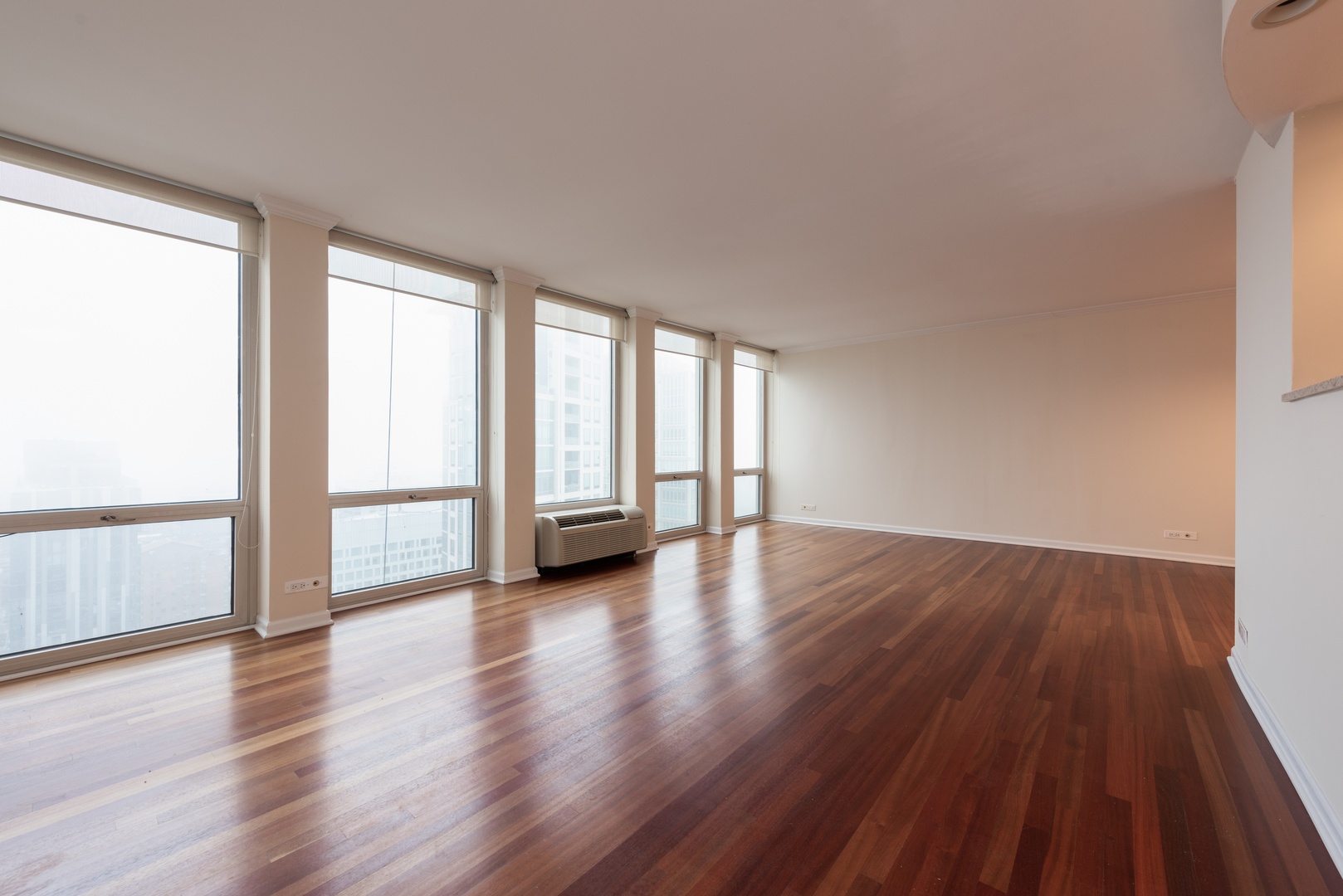 111 East Chestnut Street, Unit 45B Chicago, IL 60611 - Photo 2 of 27 a view of an empty room and wooden floor