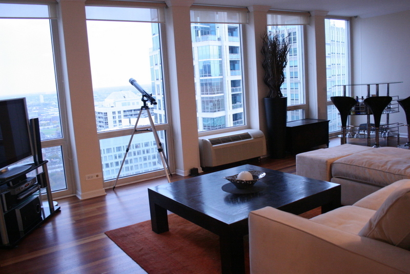 111 East Chestnut Street, Unit 45B Chicago, IL 60611 - Photo 3 of 27 a living room with furniture and a flat screen tv