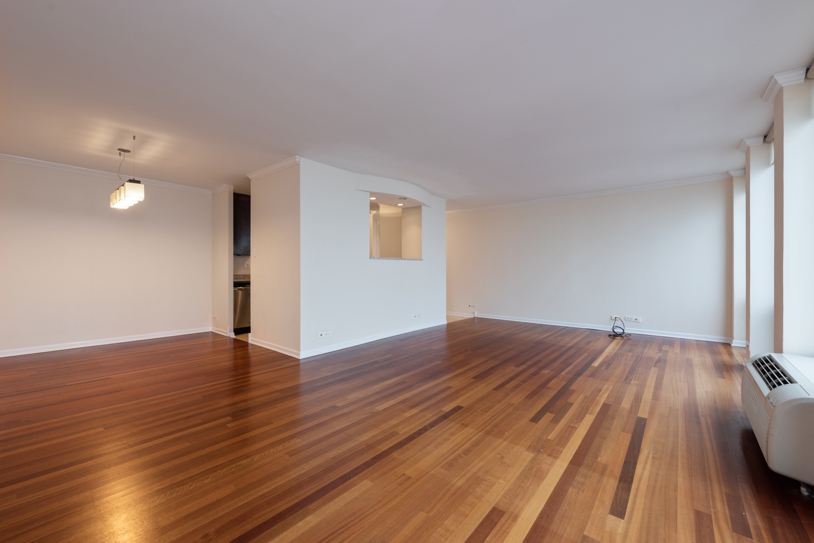111 East Chestnut Street, Unit 45B Chicago, IL 60611 - Photo 5 of 27 a view of an empty room and wooden floor