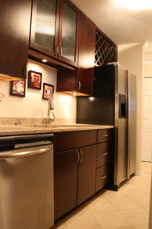 111 East Chestnut Street, Unit 45B Chicago, IL 60611 - Photo 9 of 27 a kitchen with granite countertop stainless steel appliances and refrigerator