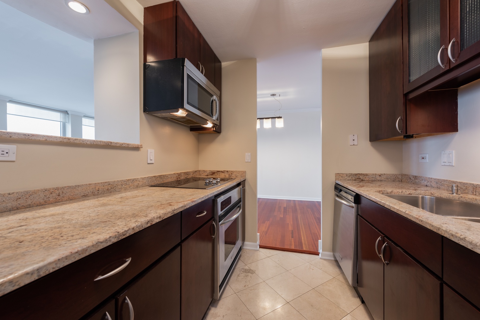 111 East Chestnut Street, Unit 45B Chicago, IL 60611 - Photo 10 of 27 a kitchen with granite countertop a sink and a stove top oven