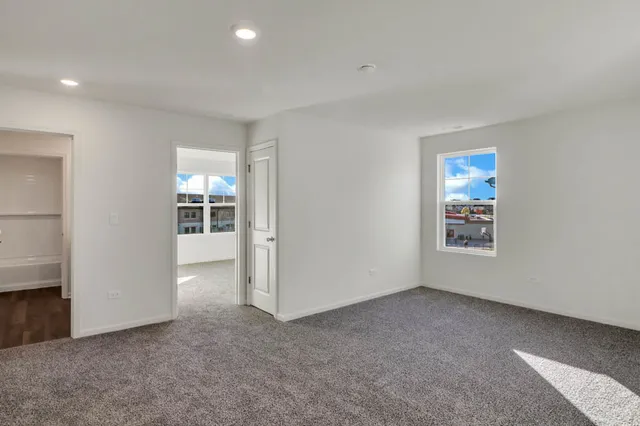a living room with furniture a fireplace and a floor to ceiling window