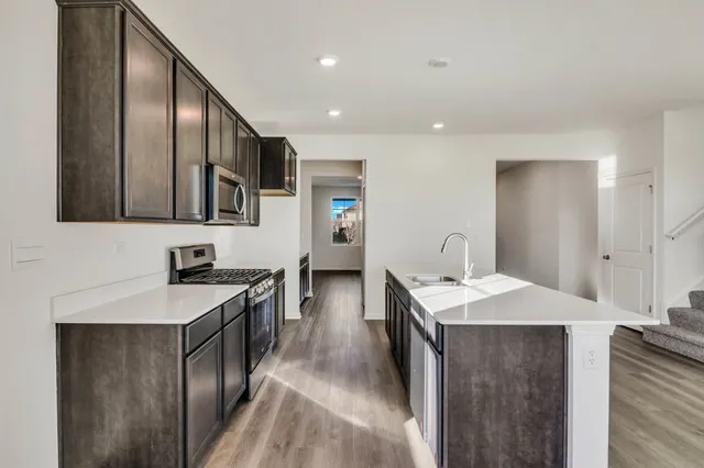 a view of a room with wooden floor and white walls