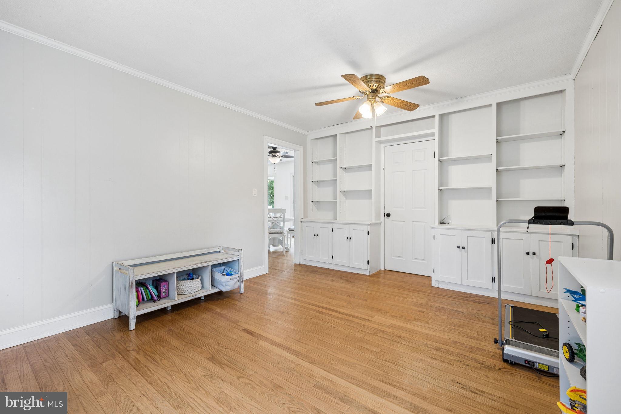 12237 Randle Lane Culpeper, VA 22701 - Photo 11 of 31 a view of a livingroom with wooden floor and a ceiling fan