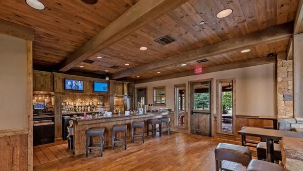 a living room with lots of furniture and a wooden floor