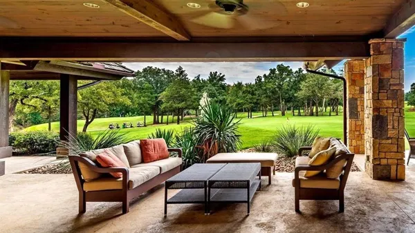 a view of a patio with couches chairs and a yard