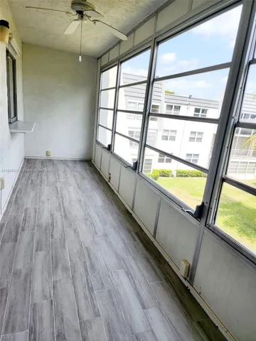a view of a room with wooden floor and furniture