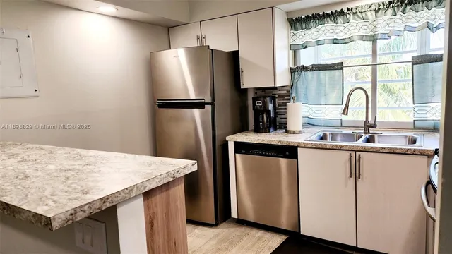 a kitchen with refrigerator and window