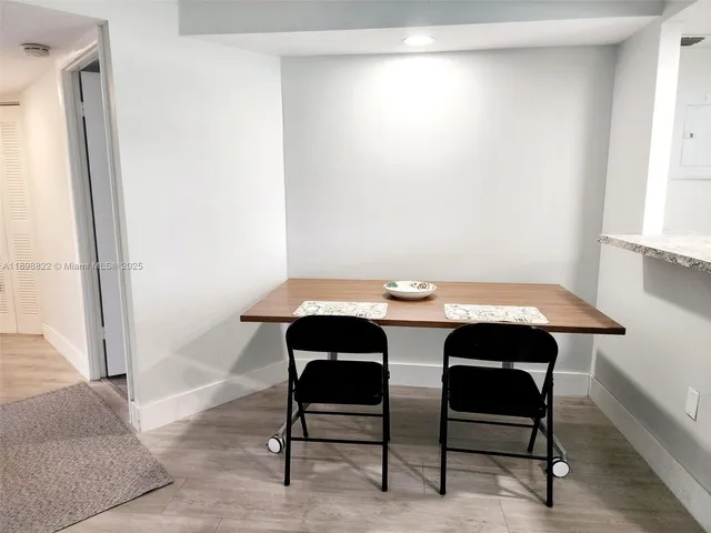 a bedroom with a bed table chair and a window