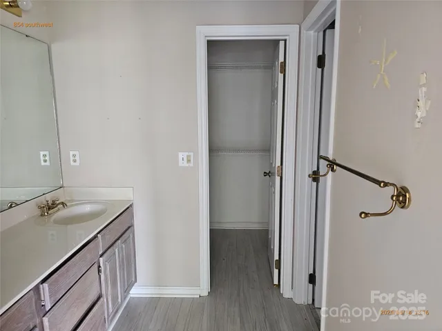 a bathroom with a granite countertop sink shower and a mirror