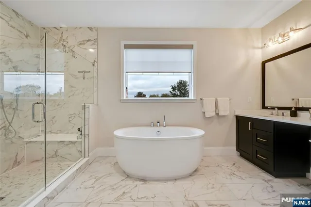 a spacious bathroom with a bathtub and a sink