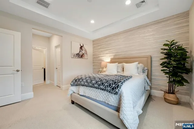 a bedroom with a bed and a potted plant