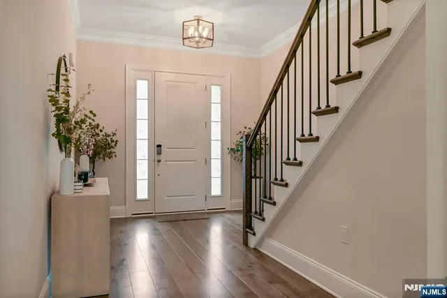 a view of entryway with wooden floor and stairs