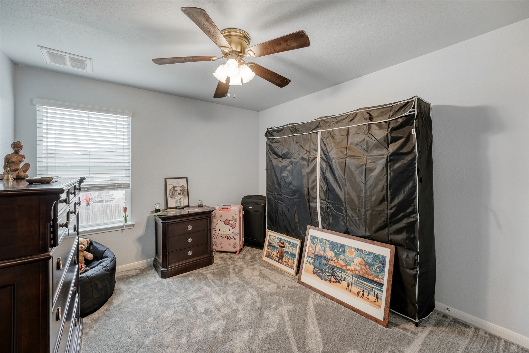15105 Shell Bark Cove Austin, TX 78724 - Photo 22 of 30 Well-lit sleeping quarters featuring soft carpeting and a ceiling fan for comfort.
