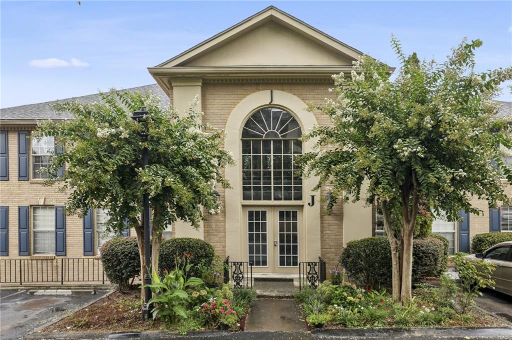 750 Dalrymple Road, Unit J3 Atlanta, GA 30328 - Photo 1 of 1 a front view of a house with garden
