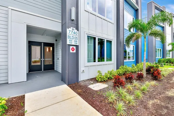 a view of a house with potted plants
