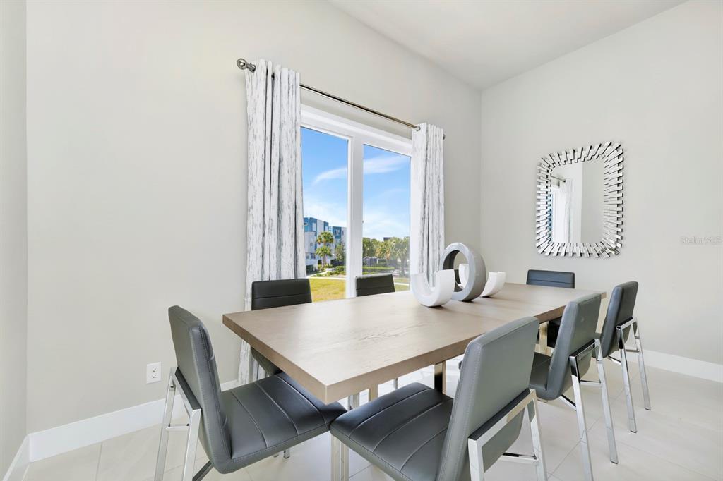 7740 Sandy Ridge Drive, Unit 220 Reunion, FL 34747 - Photo 11 of 55 a view of a dining room with furniture and window