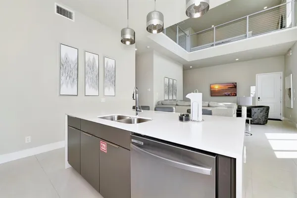 a kitchen with a sink and a refrigerator
