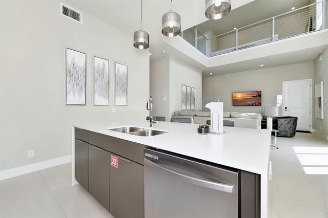 a kitchen with a sink and a refrigerator