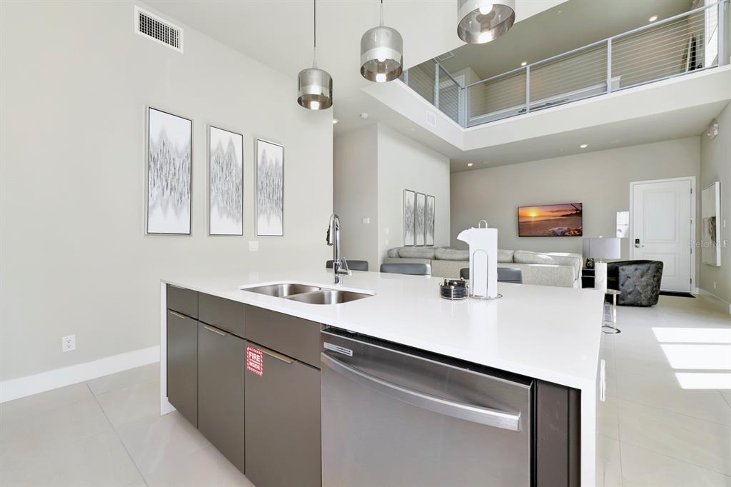7740 Sandy Ridge Drive, Unit 220 Reunion, FL 34747 - Photo 13 of 55 a kitchen with a sink and a refrigerator