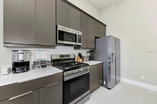 a kitchen with stainless steel appliances a stove a sink and a microwave
