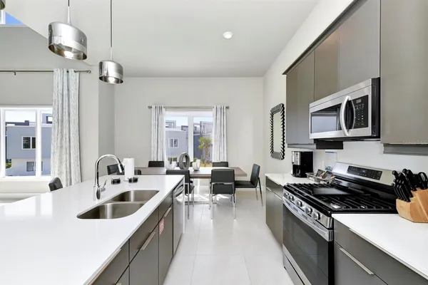 a kitchen that has a sink and a stove top oven