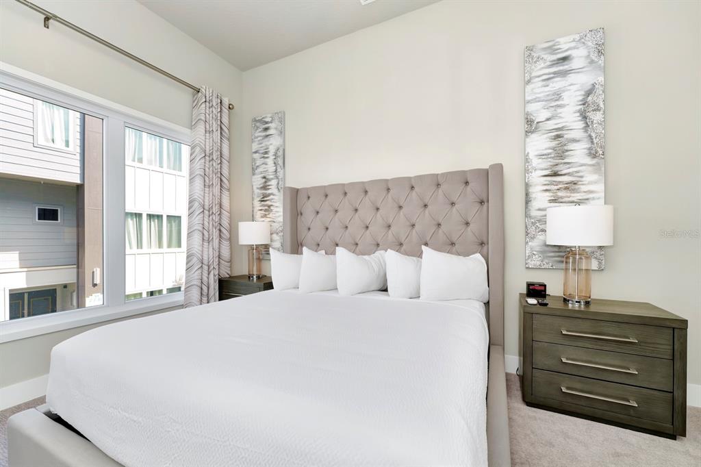 7740 Sandy Ridge Drive, Unit 220 Reunion, FL 34747 - Photo 20 of 55 a large bed sitting in a bedroom next to a window