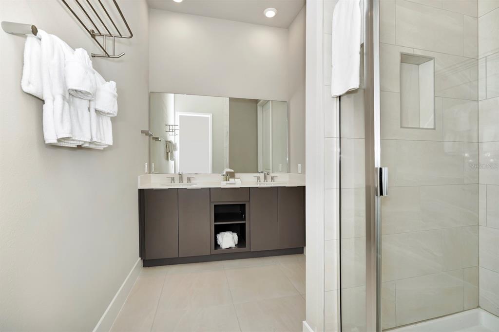 7740 Sandy Ridge Drive, Unit 220 Reunion, FL 34747 - Photo 22 of 55 a bathroom with a sink and a mirror
