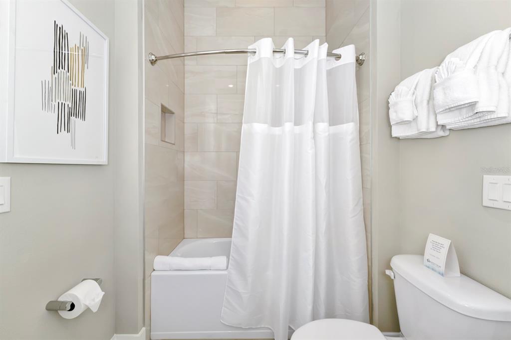 7740 Sandy Ridge Drive, Unit 220 Reunion, FL 34747 - Photo 28 of 55 a white toilet sitting next to a bathroom sink