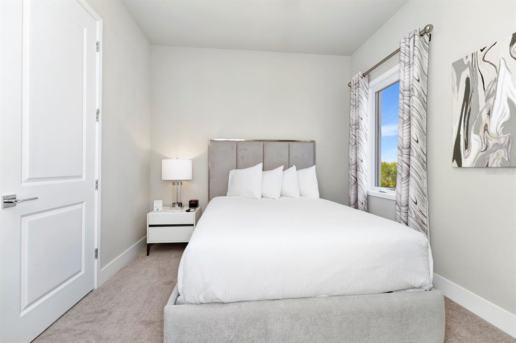 7740 Sandy Ridge Drive, Unit 220 Reunion, FL 34747 - Photo 30 of 55 a bedroom with a bed and a window