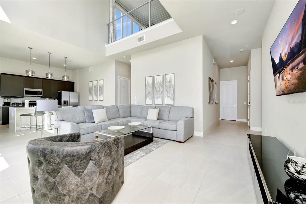 7740 Sandy Ridge Drive, Unit 220 Reunion, FL 34747 - Photo 3 of 55 a living room with furniture and a flat screen tv
