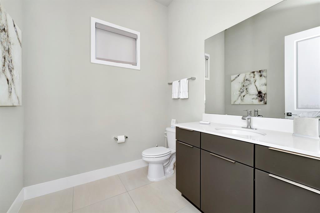 7740 Sandy Ridge Drive, Unit 220 Reunion, FL 34747 - Photo 32 of 55 a bathroom with a toilet sink and mirror