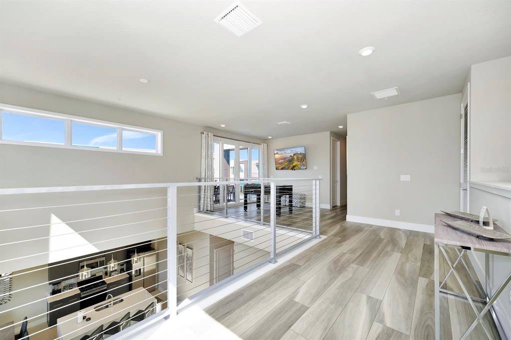 7740 Sandy Ridge Drive, Unit 220 Reunion, FL 34747 - Photo 33 of 55 a view of wooden floor and windows in a room