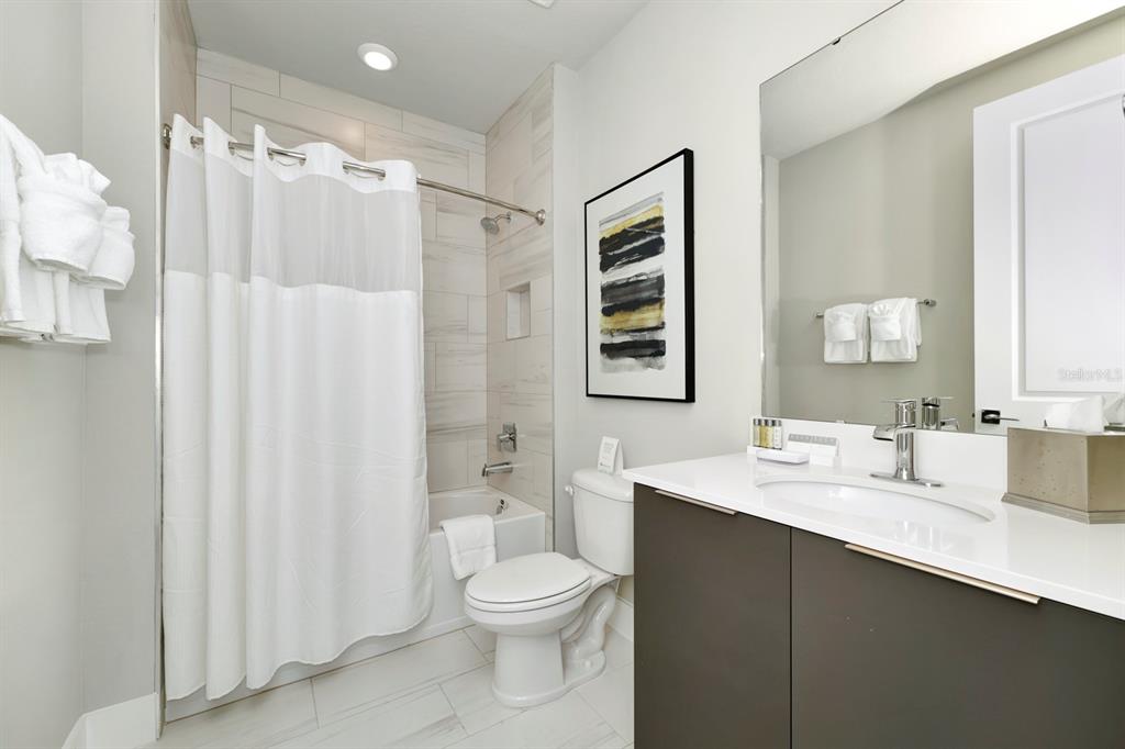 7740 Sandy Ridge Drive, Unit 220 Reunion, FL 34747 - Photo 36 of 55 a bathroom with a double vanity sink toilet and shower