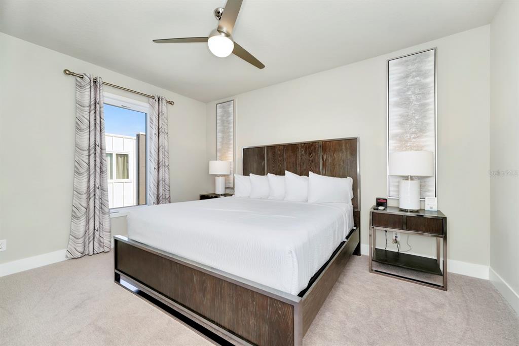 7740 Sandy Ridge Drive, Unit 220 Reunion, FL 34747 - Photo 39 of 55 a bed room with a bed and a night stand