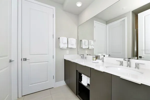 a view of a dining room and livingroom with furniture wooden floor and a chandelier