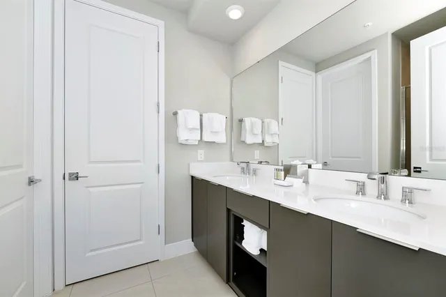 a view of a dining room and livingroom with furniture wooden floor and a chandelier