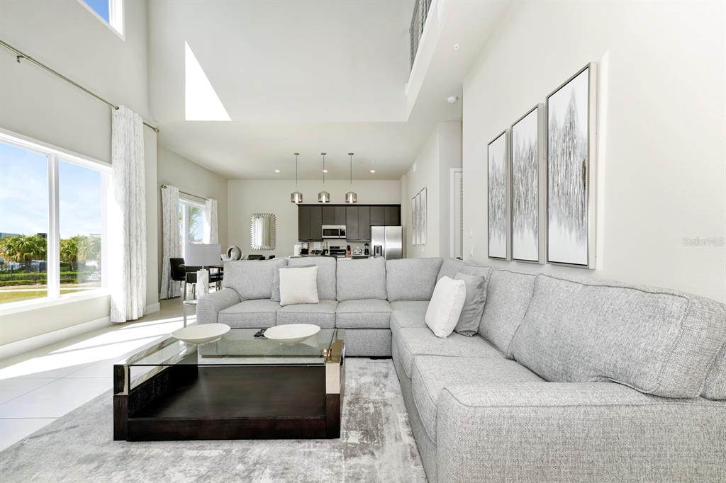 7740 Sandy Ridge Drive, Unit 220 Reunion, FL 34747 - Photo 4 of 55 a living room with furniture and a large window